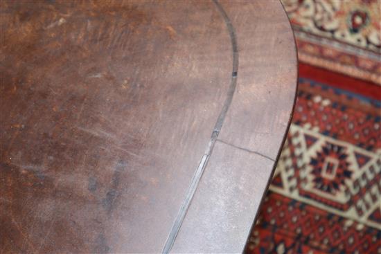 A George III mahogany and ebony strung tilt top breakfast table 143cm